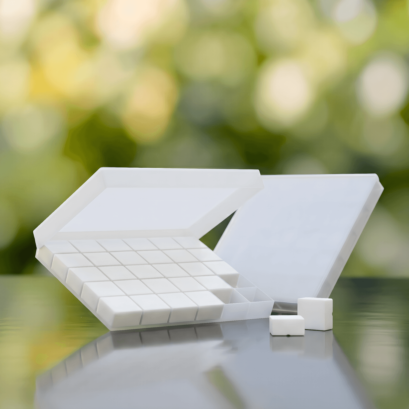 Troche tablet tray for sublingual testosterone delivery, soft green bokeh background